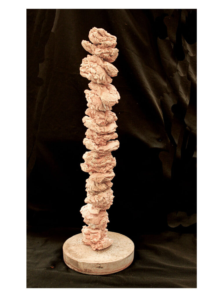 A wooden stand supporting a stack of casts of pieces of faces