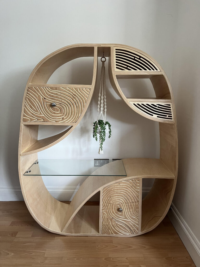  A curved shelving unit and a plant on it.