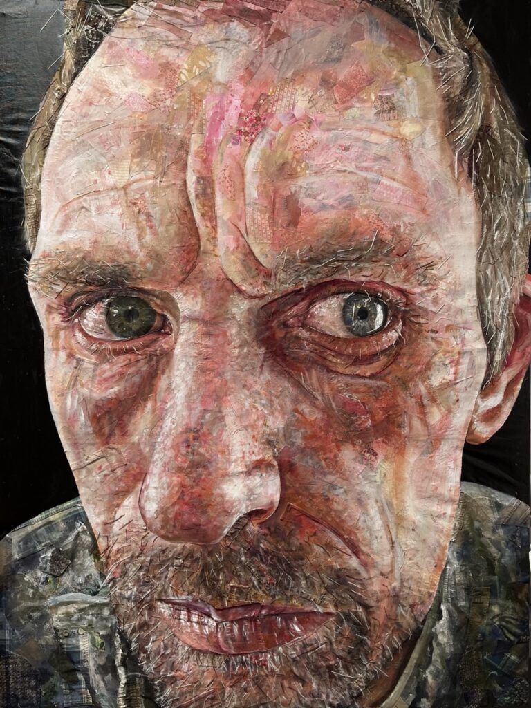 A collage-based painting of a man’s face shown in extreme close-up, constructed from layered newspaper, fabric, and stitching.